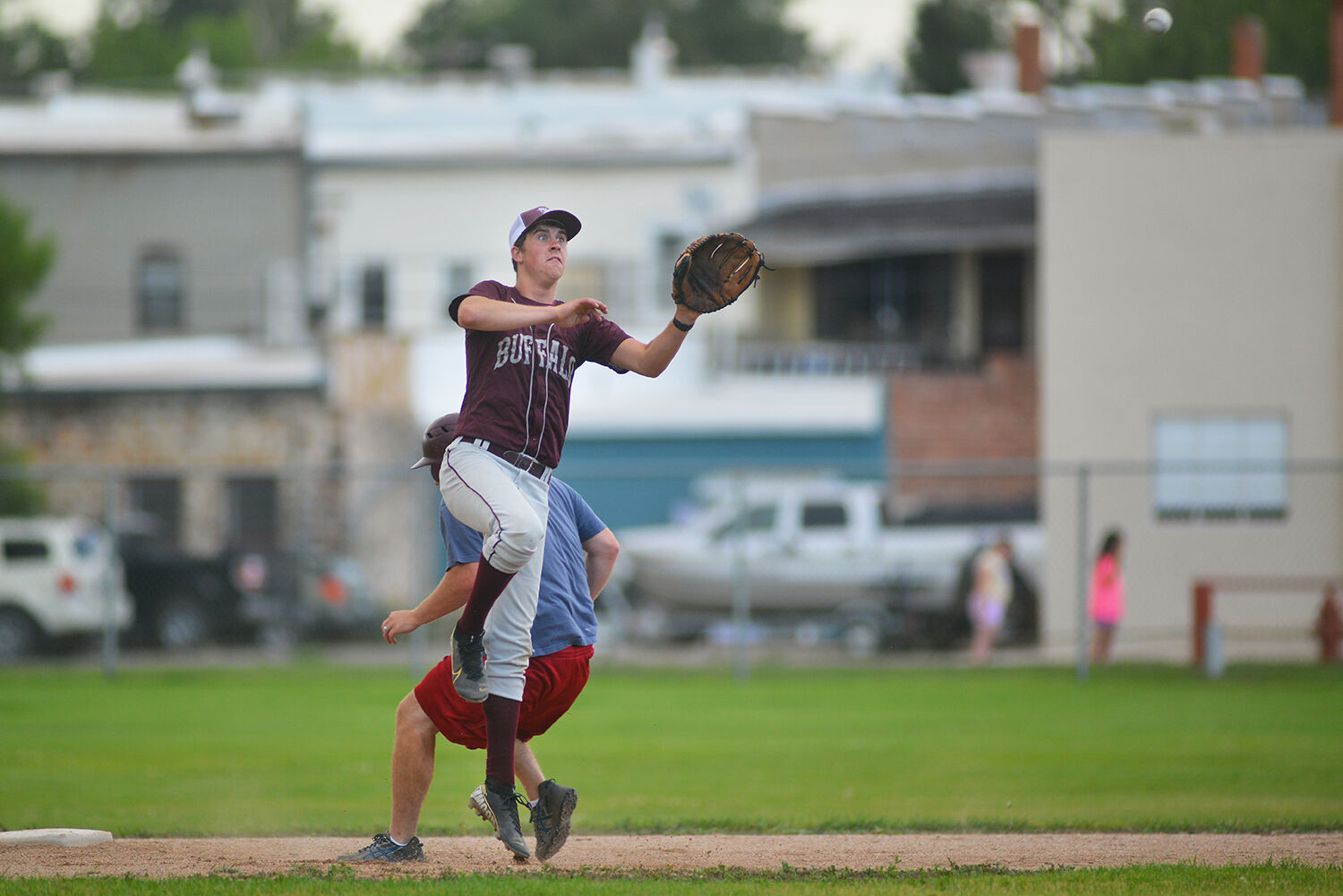 Mason Moon launches away from second base to catch the throw down